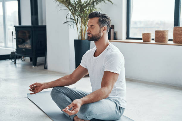 istock Concentrated young man doing yoga 1320950573
