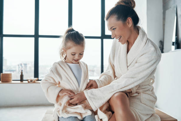 istock Mother with daughter in bathrobes 1320950587