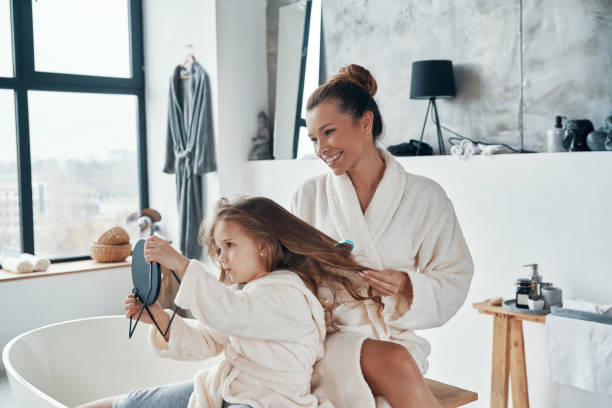 istock Beautiful young mother combining her daughter's hair 1320950638