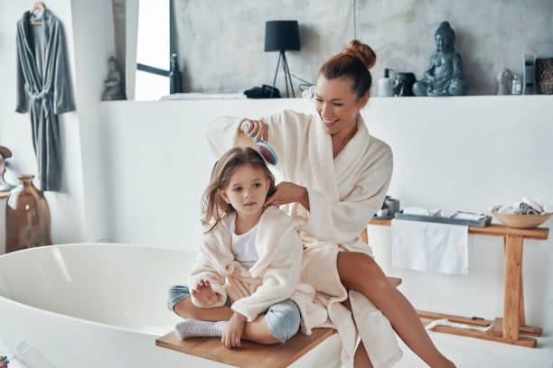 istock Happy young couple in bathrobes smiling and cleaning teeth 1320950663