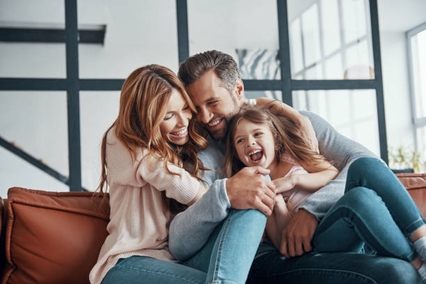 istock Happy young family smiling and embracing 1320950727