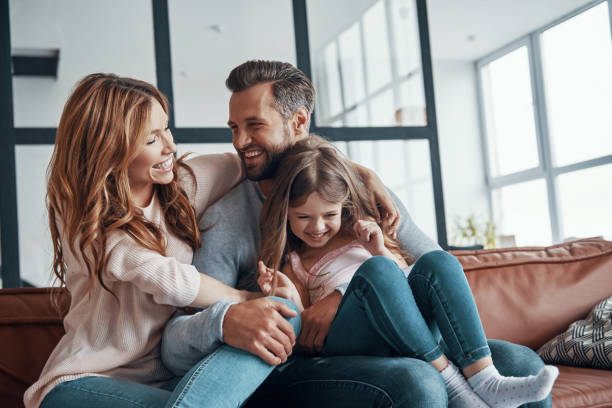 istock Happy young family smiling and embracing 1320950731