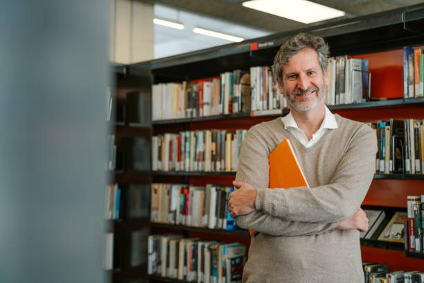 happy man at the library - professor library librarian university imagens e fotografias de stock