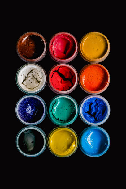 Dried gouache paint set on black background