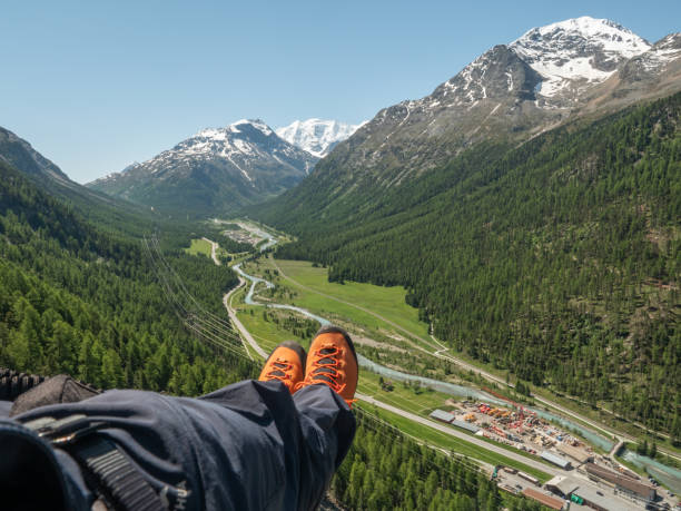 istock Climber on Via Ferrata resting on a high up bench, feet view 1320954918