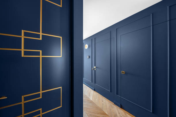 istock Blue classic wall decor in modern interior with golden line decor elements, wooden floor, hidden doors 1320956706