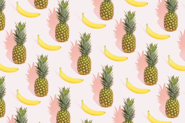 istock Summer fruit pattern on pink pastel background. Minimal summer concept. Bananas and pineapple. 1320957855
