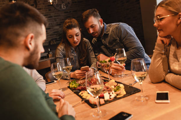 istock Group of young friends having fun in restaurant, talking and laughing while dining at table. 1320958113