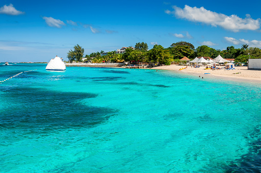 Turquoise Caribbean sea and Sunny tropical beach in Paradise island, Montego Bay, Jamaica. Summer vacation and tropical beach concept.