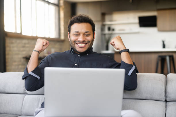 istock Happy excited indian guy celebrating victory 1320959544
