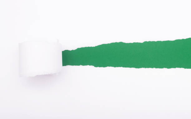 istock Tearing a paper frame hole over green background 1320960429