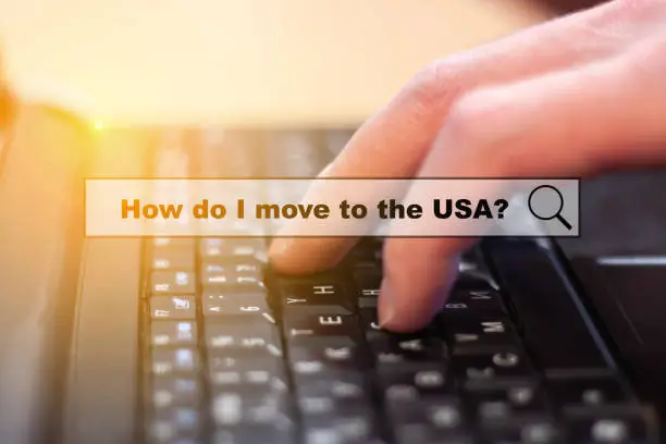 How do I move to the USA. A question when migrating to America. A man is looking for information at the computer