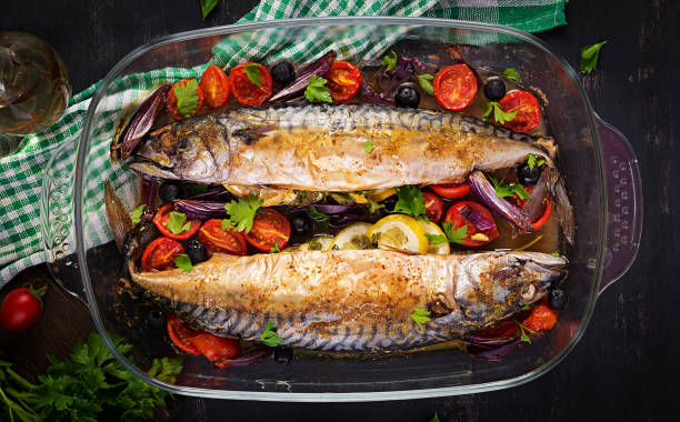 istock Baked mackerel with herbs and lemon and  vegetables. Healthy dinner. Top view, flat lay 1320966061