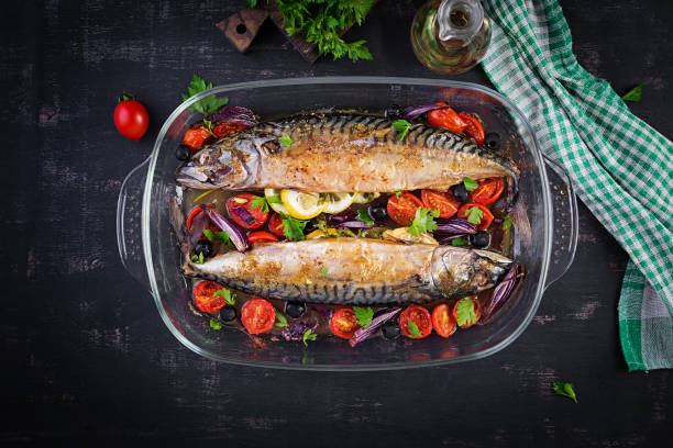 istock Baked mackerel with herbs and lemon and  vegetables. Healthy dinner. Top view, flat lay 1320966072