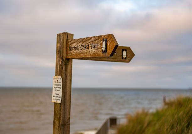 Wooden sign on the Norfolk Coastal Path with shallow depth of field and bokeh