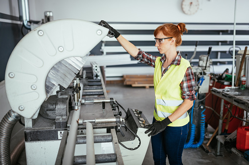 Women in blue collar jobs, working in metal processing industry