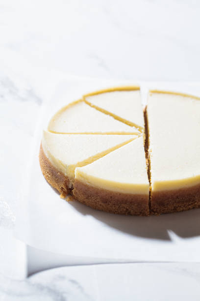 istock Traditional sliced cheesecake on white marble background. 1320968512