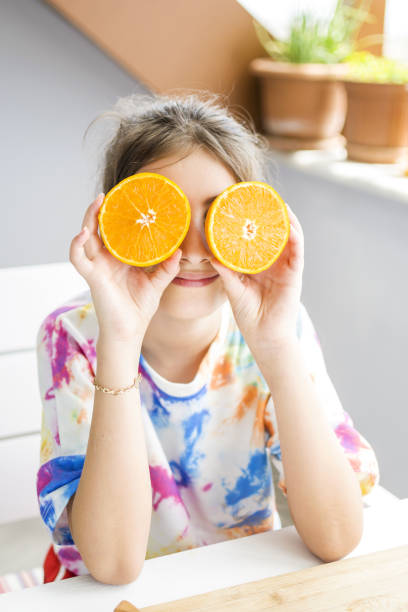 istock Beautiful girl posing with orange 1320971421