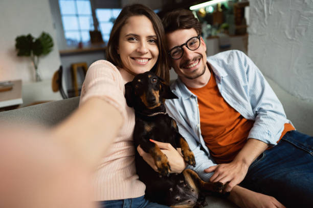 istock Young couple with dog looking at the camera 1320972336