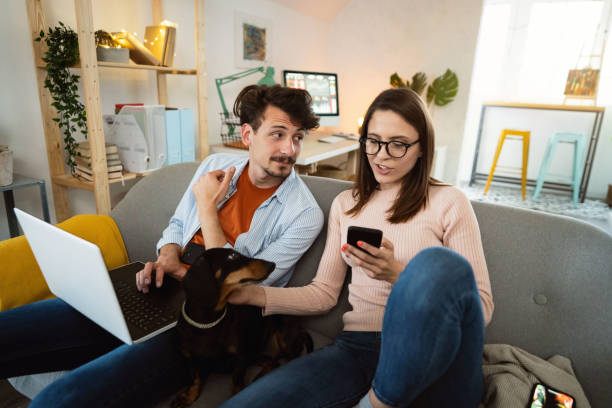 istock High-angle view of young couple tracking and trading stocks while using a laptop and a smartphone 1320972506