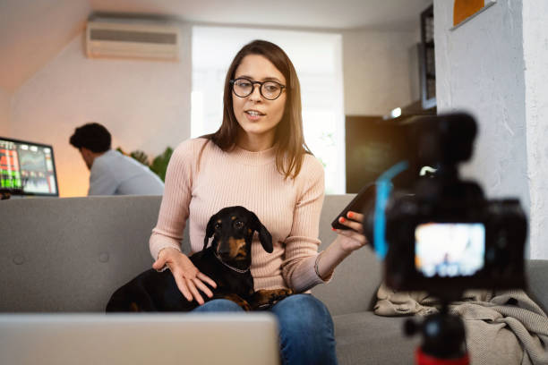 istock Front view of a young female vlogger recording video tutorial of trading 1320972579