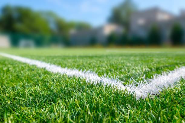 sports ground, field with artificial turf for playing soccer and other ball sport games. - soccer soccer field artificial turf man made material imagens e fotografias de stock