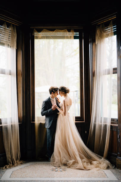 istock Young Couple Standing Near Window 1320973998