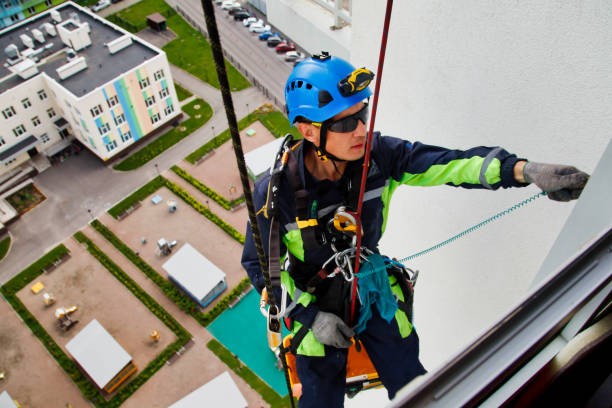 istock Industrial mountaineering worker hangs over residential facade building 1320974435