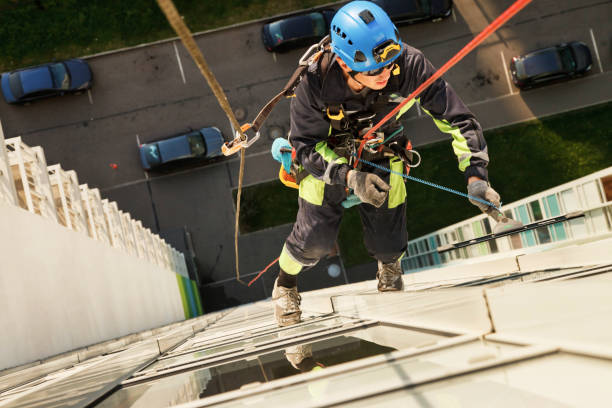 istock Industrial mountaineering worker hangs over residential facade building 1320974468