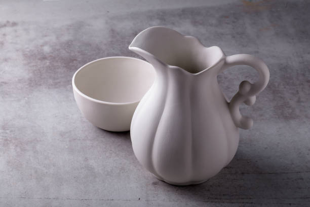 istock Teapot creamer, Cup and saucer on Cement Board 1320975377