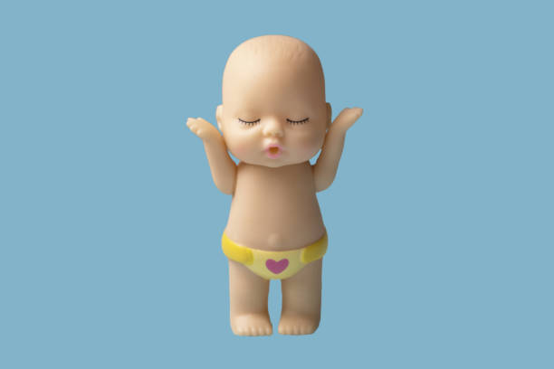 istock Little doll toy on blue background is isolate. 1320976629