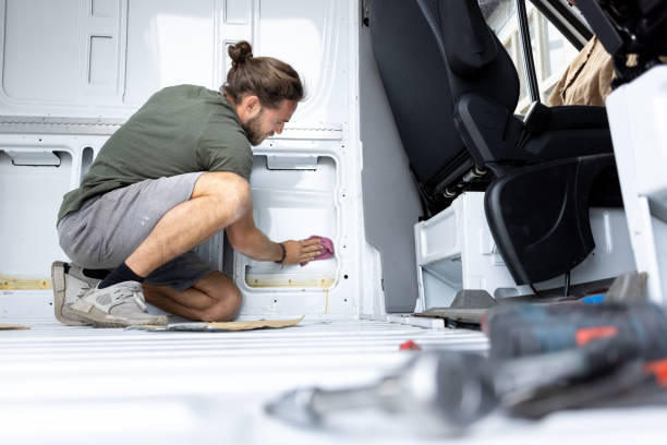 istock Man cleaning the inside of a van 1320978992