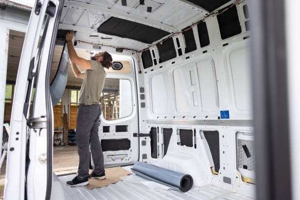 istock Man puts thermal insulation on the inside of a van 1320979108