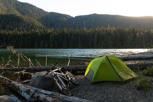 Mountain bike and tent setup by Cheakamus Lake. Camping in Whistler, Canada. Mountain bike adventure.