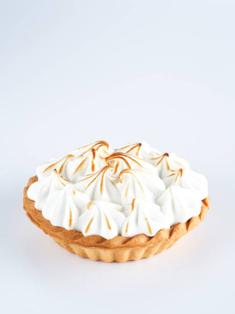 istock Lemon Curd and Meringue Mini Tart Pie on white background, selective focus, copy space. Bakery pastry dessert concept. 1320980279
