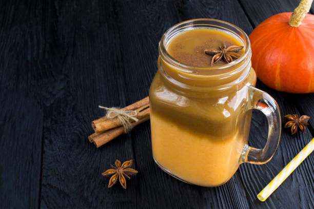 istock Pumpkin latte in the drinking glass on the black background 1320981629