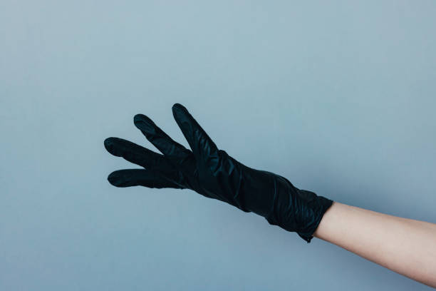 istock Female Hand in a Black Rubber Glove 1320982832