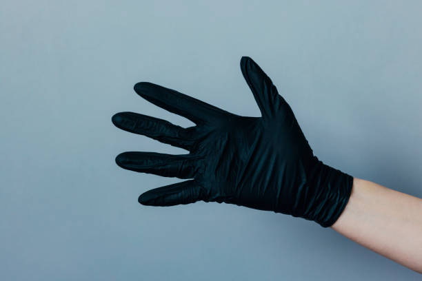istock Female Hand in a Black Rubber Glove 1320982833