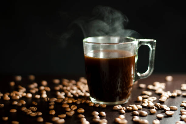 istock a cup of boiling coffee on a black wooden table 1320983320