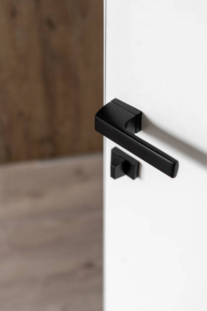 istock Matte black door handle on white interior door 1320984143