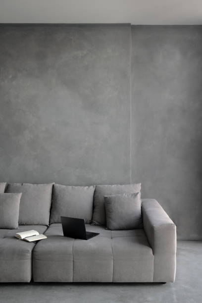 istock Laptop on modern couch in minimalist living room 1320984170