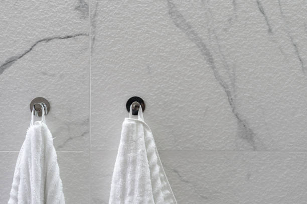 istock Bathroom wall with two towels hanging on hooks 1320984208