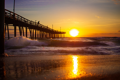 Beach sunrise outer banks east coast sun lighting waves pier