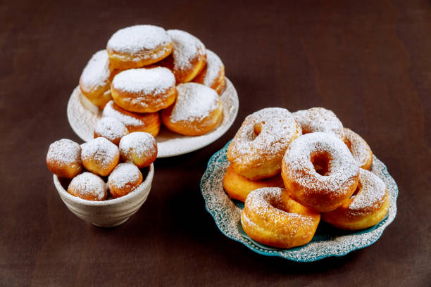 istock Donuts in white plate powdering with sugar. 1320986502