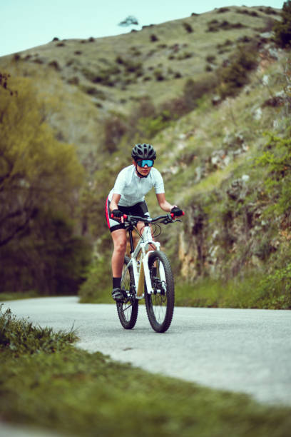 istock Female Cyclist Not Afraid Of Steep Mountain Hillside 1320986557