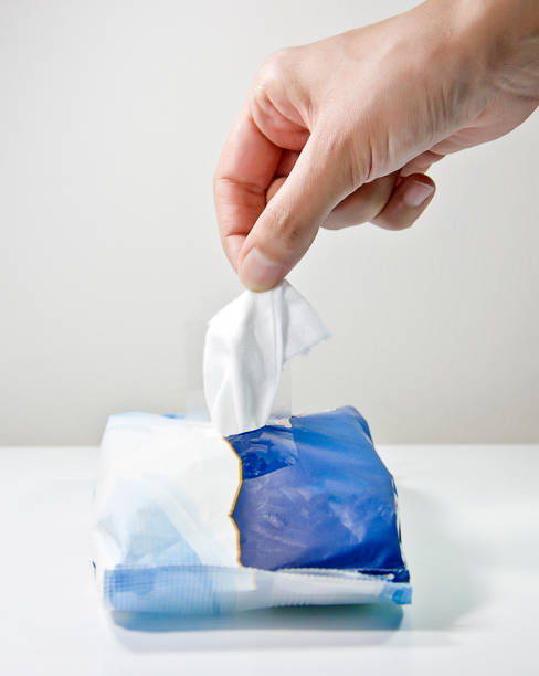 istock Woman disinfecting his hands with a wet wipe 1320986594