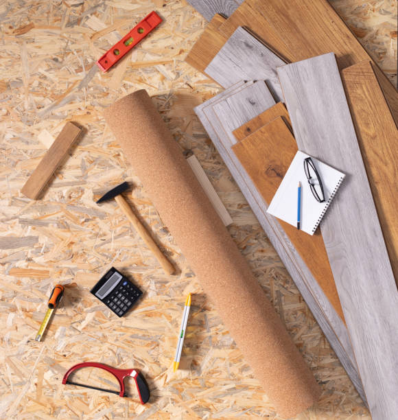 istock Laminate floor on wood background texture and tools. Wooden laminate floor plank 1320989002