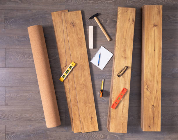 istock Laminate floor on wood background texture and tools. Wooden laminate floor plank 1320989006