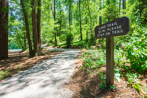 Hoover, Alabama, USA - May 1, 2021: Sign on the Lake Trail within Aldridge Gardens, a beautiful 30-acre botanical garden open to the public.