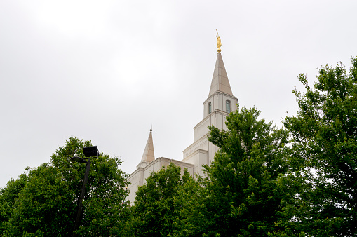 May 17, 2021 - Kansas City, Missouri, USA: This sacred building is owned and maintained by the Church of Jesus Christ of Latter-day Saints. The temple was completed in 2012 and has been operational ever since.  This shot was taken on a wet spring day with cloudy skies in the background but lush greenery surrounding the building.
